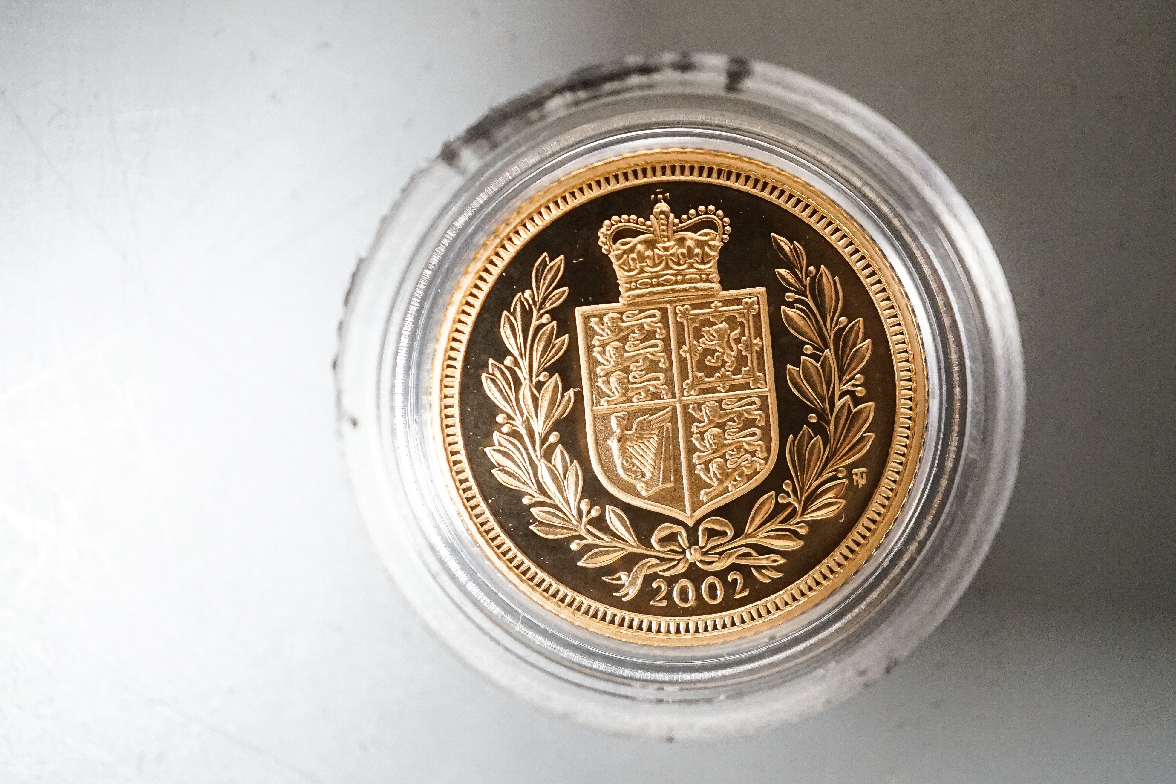 A Queen Elizabeth II gold proof half sovereign 2002 and a London mint Tristan Da Cunha gold piedfort one crown, cased with certificates (2)
